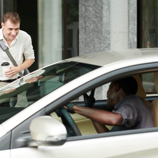 Happy man greeting taxi driver to came to pick him up